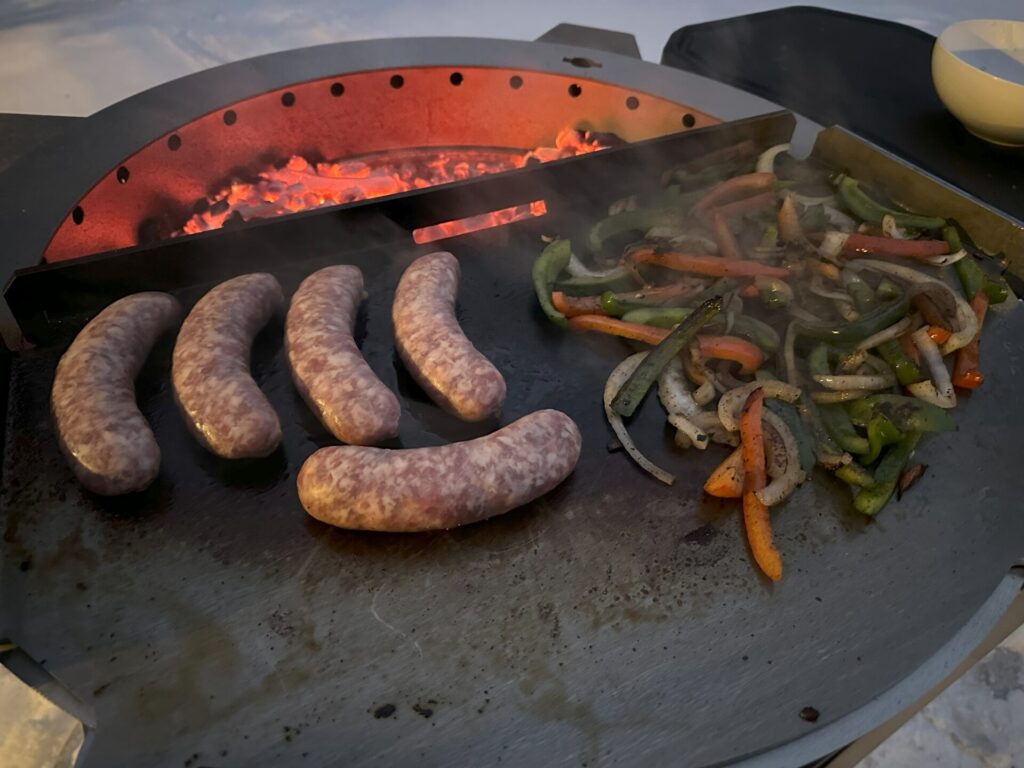 Breeo Live-Fire Grill - Cooking Brats